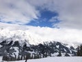 Downhill slope and apres ski and beautiful view of the Alps mountains Royalty Free Stock Photo