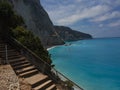Downhill stairs to Milos beach in a sunny day Royalty Free Stock Photo
