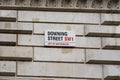 Downing Street Sign Attached to Wall by the Gates into Downing Street in Westminster, London.