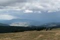 Downpour over mountain with gloomy clouds