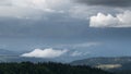 Downpour over mountain with gloomy clouds