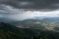 Downpour over mountains and gloomy clouds