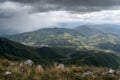 Downpour over mountains and gloomy clouds