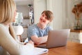 Downs Syndrome Man Sitting With Home Tutor Using Laptop For Lesson At Home Royalty Free Stock Photo