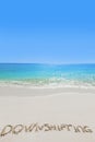 Downshifting text on sandy beach Royalty Free Stock Photo