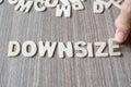 DOWNSIZE word of wooden alphabet letters. Business and Idea