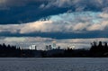 Downtown Bellevue gleaming in sunshine with moody dark sky Royalty Free Stock Photo