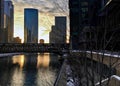 Downtown Chicago as evening sets and reflects cityscape onto Chicago River during winter. Royalty Free Stock Photo