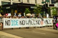 Protest against ICE. Front line marchers with banner `No ICE, No Wall, No USA at All`