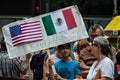 Protest against Immigration ICE and Border Patrol. Boy with American flag and Mexican flag Royalty Free Stock Photo