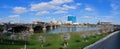 Downtown City Skyline Indianapolis Indiana White River in spring with blooming trees and vegetation, pedestrian bridges and ruins. Royalty Free Stock Photo
