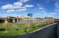 Downtown City Skyline Indianapolis Indiana White River in spring with blooming trees and vegetation, pedestrian bridges and ruins. Royalty Free Stock Photo