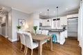 A downtown condo dining room and white kitchen.