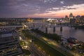 Downtown district of Cincinnati city in Ohio, USA at night with driving cars traffic on bridge and brightly illuminated Royalty Free Stock Photo