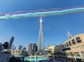 Downtown Dubai landmarks and attractions - View of Burj Khalifa and Dubai Mall - UAE flag create by smoke from planes Royalty Free Stock Photo