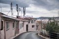 Downtown house with antenna on the roof. Grey sky with clouds in the background