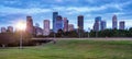 Downtown Houston from Police Memorial park at dramatic sunset. Green park lawn and modern skylines. The most populous city in