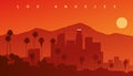 Downtown Los Angeles at sunset. Skyline silhouette with mountains in the background and palms in the foreground, California