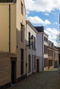 Downtown Maastricht, winding small cobblestone streets with old house which none of them is straight under a dramatic sky.