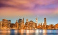 Downtown Manhattan at night from Brooklyn Bridge Park. New York City skyscrapers reflections in the river Royalty Free Stock Photo