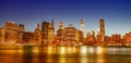 Downtown Manhattan at night from Brooklyn Bridge Park. New York City skyscrapers reflections in the river Royalty Free Stock Photo