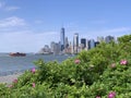 Downtown Manhattan with Staten Island ferry behind the green of Governor Island Royalty Free Stock Photo