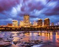 Downtown Richmond Skyline by James River, glowing city lights in business district of RVA Downtown with moving clouds in a long ex