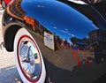 Downtown Sapulpa Oklahoma reflected in the black fender of a restored automobile. Blue sky above. At an auto show on Route 66. Royalty Free Stock Photo