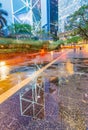 Downtown skyscrapers with road reflections at night, Hong Kong. Royalty Free Stock Photo