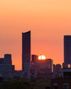 Downtown Toronto at sunrise, with warm golden light in the sky behind silhouettes of the skyline buildings Royalty Free Stock Photo