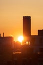 Downtown Toronto at sunrise, with warm golden light in the sky behind silhouettes of the skyline buildings Royalty Free Stock Photo