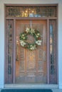 Downtown Tucson, Arizona- Carved door with wreath and railings on the transom window and sidelights Royalty Free Stock Photo