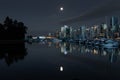 Downtown vancouver canada on a clear night with a full moon reflection Royalty Free Stock Photo