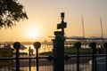 Downtown waterfront sunrise golden glow back-lights in silhouette barrier and railway signs