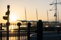 Downtown waterfront sunrise golden glow back-lights in silhouette barrier and railway signs