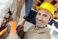 Downward view builder holding sledge hammer