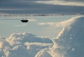 Dozen birds on a light wire with clouds