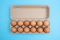 Dozen eggs in open carton.