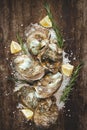 Dozen fresh oysters on the wooden and sea salt. Top view