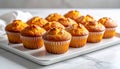 A dozen golden brown freshly baked corn muffins arranged on a white rectangular tray Keywords: muffin, corn muffin Royalty Free Stock Photo