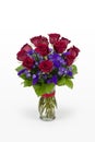 One dozen red roses with purple flowers arranged in a glass vase. Romantic vase of Roses.