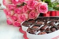 Beautiful Soft Pink Roses with a Heart Shape Box of Chocolate Candy Royalty Free Stock Photo