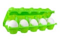 Dozen white eggs in open green plastic package on white background isolated close up side view Royalty Free Stock Photo