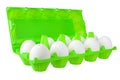 Dozen white eggs in open green plastic package on white background isolated close up side view Royalty Free Stock Photo