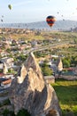 Dozens of balloons fly over the city of Goreme in Turkey and over the valleys of Cappadocia Royalty Free Stock Photo