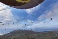 Dozens of balloons fly over the valleys in Cappadocia Royalty Free Stock Photo