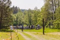 Dozens of bicycles and riders on glade in the forest