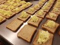 Dozens of egg salad sandwiches on metal table at the soup kitchen, feeding the hungry