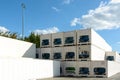 Dozens of immaculate white refrigerated containers stacked in the sunlight in an industrial park