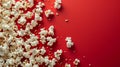 Popcorn spilled out onto a red background. Created using ai generative.